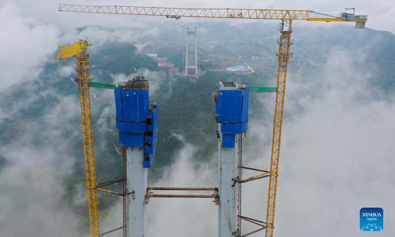Aerial photo taken on Nov. 21, 2021 shows the main tower of Tongzi River grand bridge in southwest China's Guizhou Province. The main tower of the Tongzi River grand bridge was capped on Sunday. The 1,422-meter-long bridge is an important part of the Jinsha-Renhuai-Tongzi Highway.(Xinhua)
