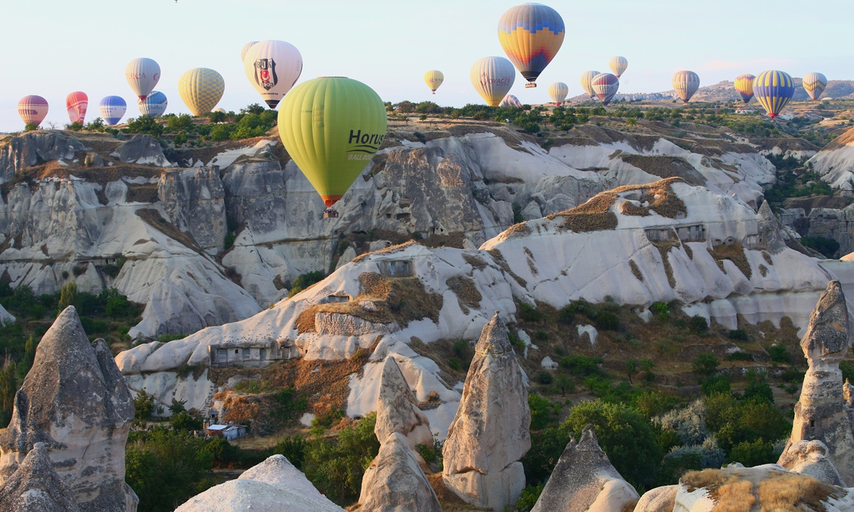 Hot air balloons glide over historical Cappadocia region, located in Nevsehir province of Turkey on August 10.  Photo: VCG