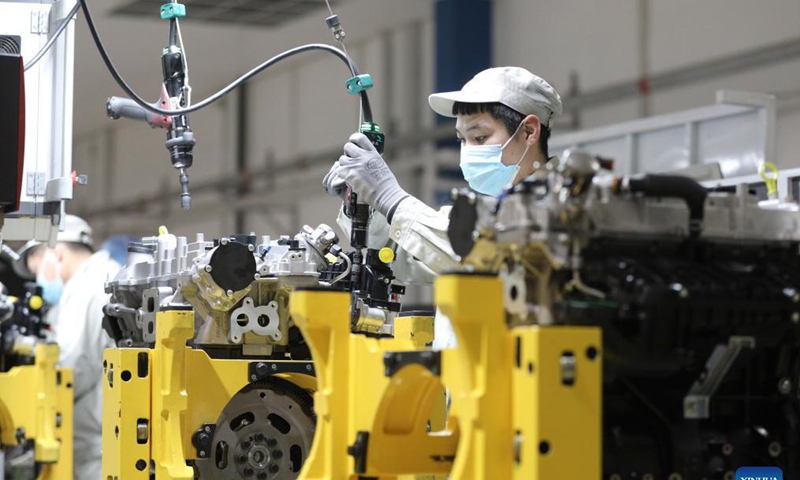 A worker assembles an engine at a manufacturer in Harbin, northeast China's Heilongjiang Province, Nov. 18, 2021. Harbin terminated its emergency responses to COVID-19 on Thursday and started advancing the full restoration of the normal economic and social order after the recent resurgence of COVID-19 has been subdued. Photo: Xinhua