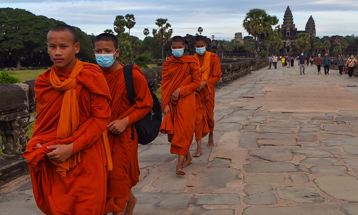 Buddhist monks walk in the Angkor Wat compound. Photo: AFP
