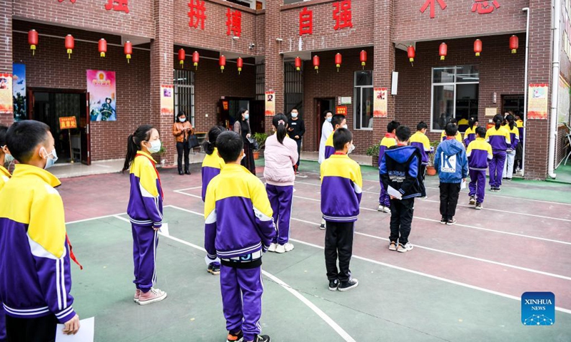 Pupils line up to get inoculated with the COVID-19 vaccines at Weiming elementary school in Weiming Village, Shinan Township, Xingye County, south China's Guangxi Zhuang Autonomous Region, Nov. 18, 2021. Photo: Xinhua