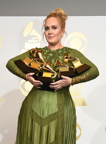 Adele poses in the press room with her trophies, including the top two Grammys for Album and Record of the Year, on February 12, 2017, in Los Angeles, California. Photo: AFP 