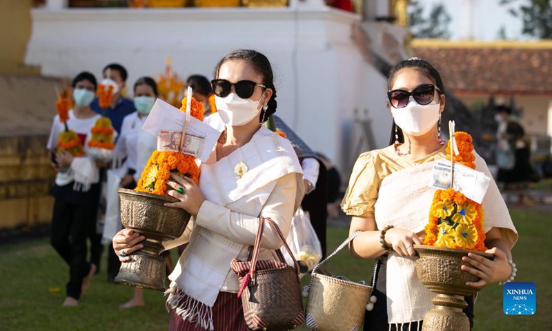 People pray around the That Luang Stupa in Vientiane, Laos, Nov. 18, 2021. The That Luang Festival, the most important religious festival in Laos, was observed by Lao people from all over the country around the That Luang Stupa. (Photo by Kaikeo Saiyasane/Xinhua)