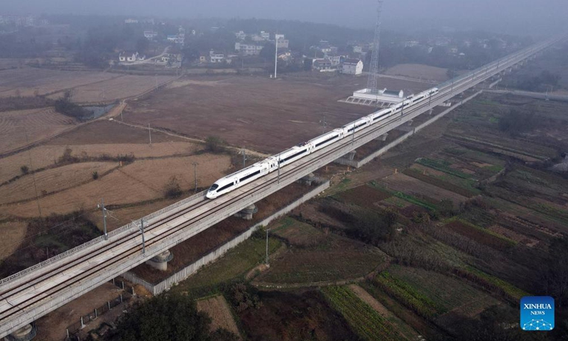 Aerial photo shows a train running in the Anqing-Huangmei section of the Anqing-Jiujiang high-speed railway in Anqing, east China's Anhui Province, Nov 19, 2021. The trial operation of the Anqing-Huangmei section of the Anqing-Jiujiang high-speed railway began on Friday.Photo:Xinhua