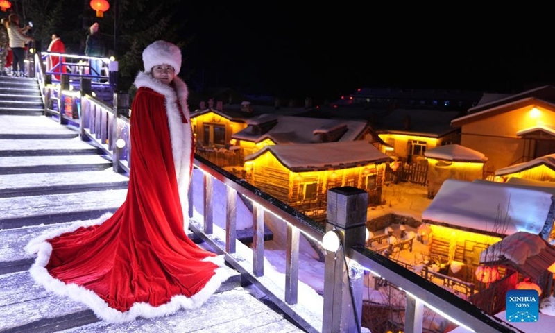 A tourist poses for photos at Shuangfeng Forest Farm in northeast China's Heilongjiang Province, Nov 18, 2021. Shuangfeng Forest Farm, dubbed Snow Town of China, receives up to 180 days of snow every year, and the average annual snow thickness is 2.6 meters.Photo:Xinhua