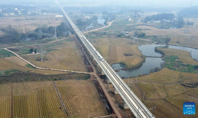 Aerial photo shows a train running in the Anqing-Huangmei section of the Anqing-Jiujiang high-speed railway in Anqing, east China's Anhui Province, Nov 19, 2021. The trial operation of the Anqing-Huangmei section of the Anqing-Jiujiang high-speed railway began on Friday.Photo:Xinhua