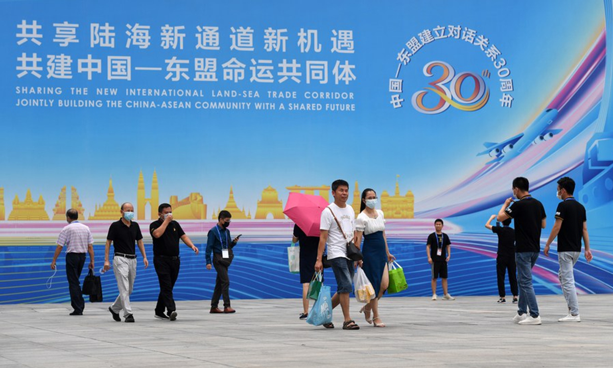 People walk out of the venue of the 18th China-ASEAN Expo in Nanning, capital of south China's Guangxi Zhuang Autonomous Region, Sept. 13, 2021. (Xinhua/Lu Boan)