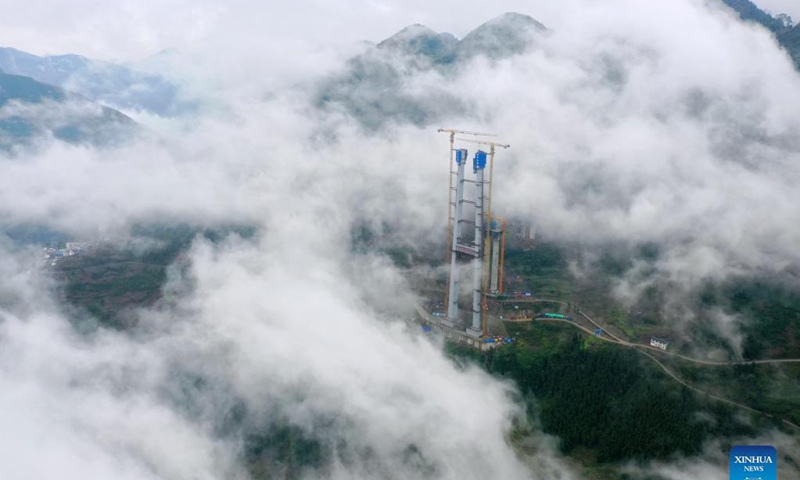 Aerial photo taken on Nov. 21, 2021 shows the main tower of Tongzi River grand bridge in southwest China's Guizhou Province. The main tower of the Tongzi River grand bridge was capped on Sunday. The 1,422-meter-long bridge is an important part of the Jinsha-Renhuai-Tongzi Highway. Photo: Xinhua