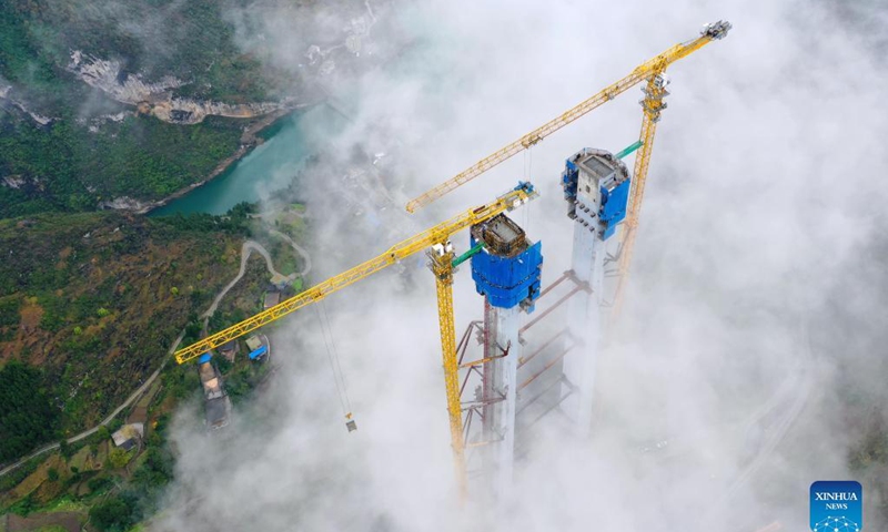 Aerial photo taken on Nov. 21, 2021 shows the main tower of Tongzi River grand bridge in southwest China's Guizhou Province. The main tower of the Tongzi River grand bridge was capped on Sunday. The 1,422-meter-long bridge is an important part of the Jinsha-Renhuai-Tongzi Highway. Photo: Xinhua