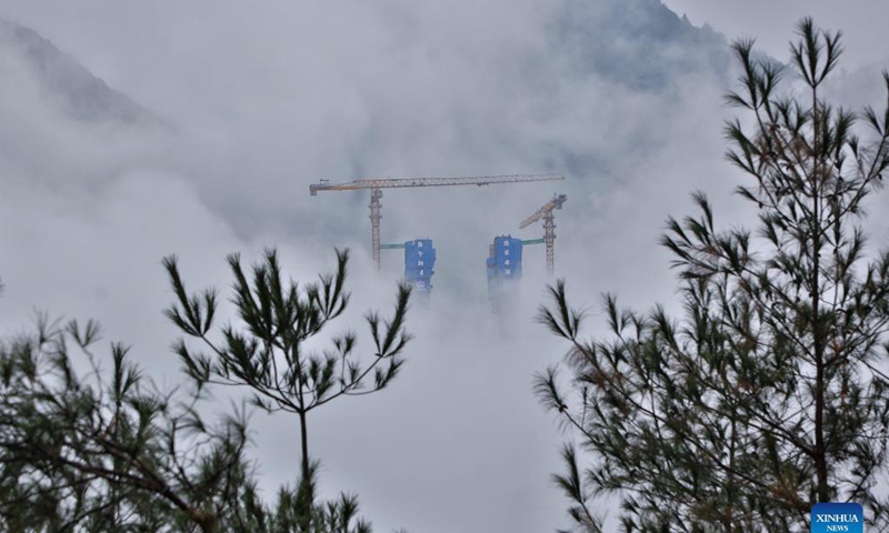 Aerial photo taken on Nov. 21, 2021 shows the main tower of Tongzi River grand bridge in southwest China's Guizhou Province. The main tower of the Tongzi River grand bridge was capped on Sunday. The 1,422-meter-long bridge is an important part of the Jinsha-Renhuai-Tongzi Highway. Photo: Xinhua