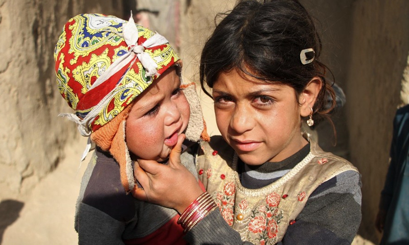 An Afghan child holds her little brother at an internally displaced persons (IDPs) camp in Kabul, capital of Afghanistan, Nov. 20, 2021.Photo:Xinhua