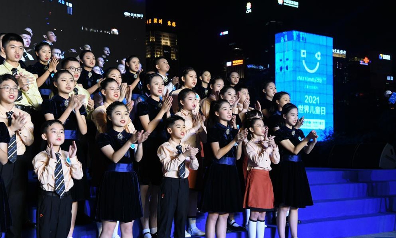Children from Shenzhen in south China's Guangdong Province and South China's Hong Kong sing songs to celebrate World Children's Day at a lighting ceremony in Shenzhen, Nov. 20, 2021.Photo:Xinhua