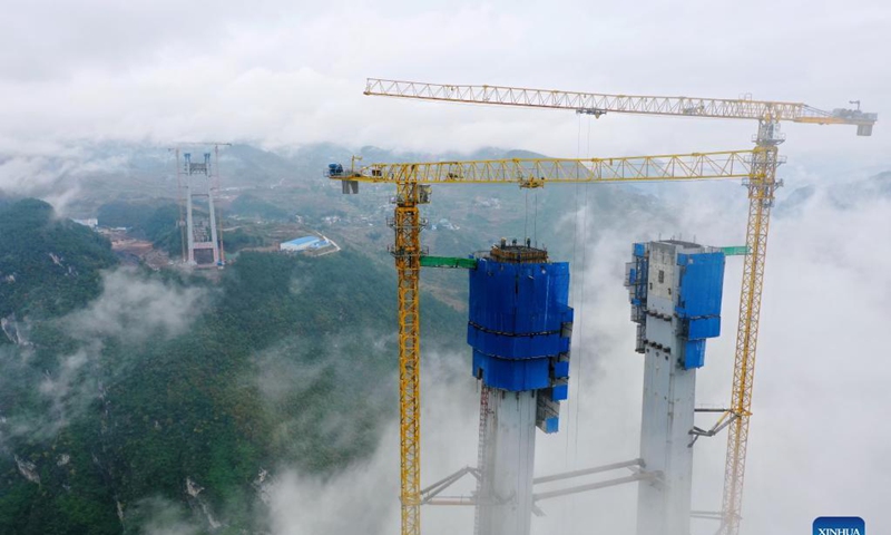 Aerial photo taken on Nov. 21, 2021 shows the main tower of Tongzi River grand bridge in southwest China's Guizhou Province. The main tower of the Tongzi River grand bridge was capped on Sunday. The 1,422-meter-long bridge is an important part of the Jinsha-Renhuai-Tongzi Highway. Photo: Xinhua