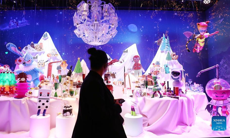 Pedestrians look at the Christmas window display at the Galeries Lafayette department store, in Paris, France, Nov. 21, 2021. Department stores have unveiled their Christmas window displays for the upcoming festival.Photo: Xinhua