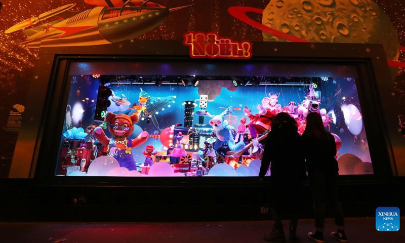 Pedestrians look at the Christmas window display at the Galeries Lafayette department store, in Paris, France, Nov. 21, 2021. Department stores have unveiled their Christmas window displays for the upcoming festival.Photo: Xinhua