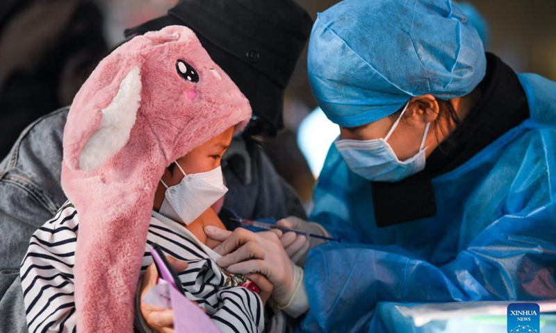 A kid receives a dose of COVID-19 vaccine at a school in Hohhot, north China's Inner Mongolia Autonomous Region, Nov. 23, 2021. Hohhot recently launched a COVID-19 vaccination campaign for children aged 3 to 11.Photo: Xinhua