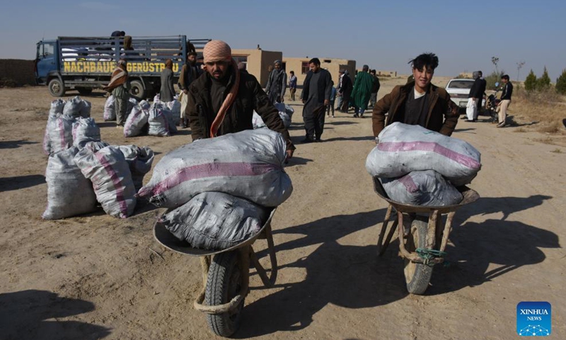People receive relief assistance donated by a local philanthropist in Nahr Shahi district of Balkh province, Afghanistan, Nov. 21, 2021.Photo:Xinhua