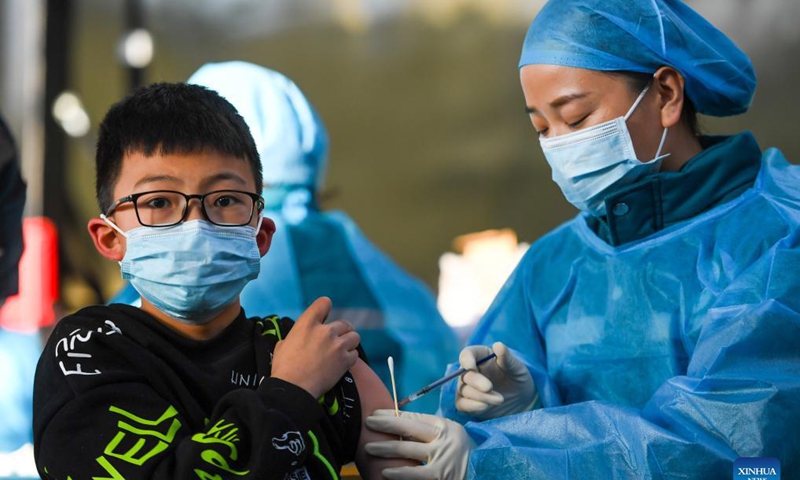 A kid receives a dose of COVID-19 vaccine at a school in Hohhot, north China's Inner Mongolia Autonomous Region, Nov. 23, 2021. Hohhot recently launched a COVID-19 vaccination campaign for children aged 3 to 11.Photo: Xinhua