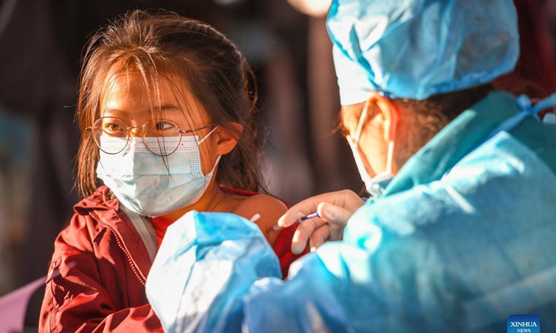A kid receives a dose of COVID-19 vaccine at a school in Hohhot, north China's Inner Mongolia Autonomous Region, Nov. 23, 2021. Hohhot recently launched a COVID-19 vaccination campaign for children aged 3 to 11.Photo: Xinhua