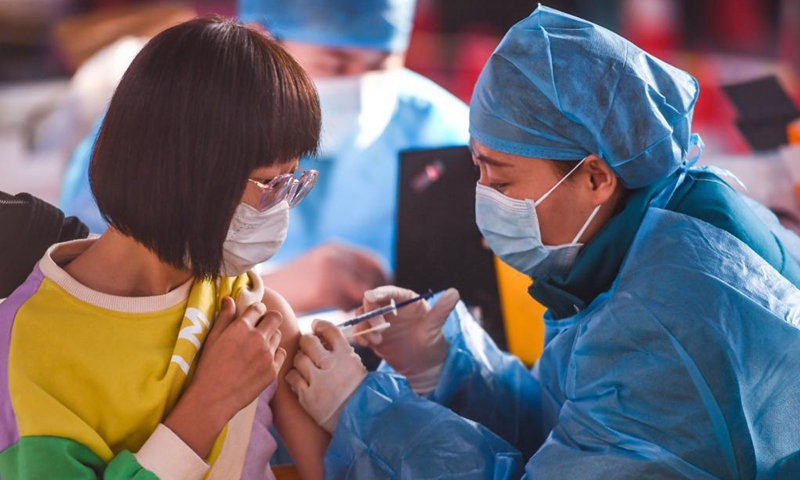 A kid receives a dose of COVID-19 vaccine at a school in Hohhot, north China's Inner Mongolia Autonomous Region, Nov. 23, 2021. Hohhot recently launched a COVID-19 vaccination campaign for children aged 3 to 11.Photo: Xinhua