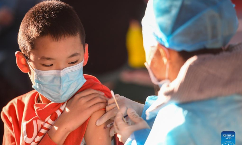 A kid receives a dose of COVID-19 vaccine at a school in Hohhot, north China's Inner Mongolia Autonomous Region, Nov. 23, 2021. Hohhot recently launched a COVID-19 vaccination campaign for children aged 3 to 11.Photo: Xinhua