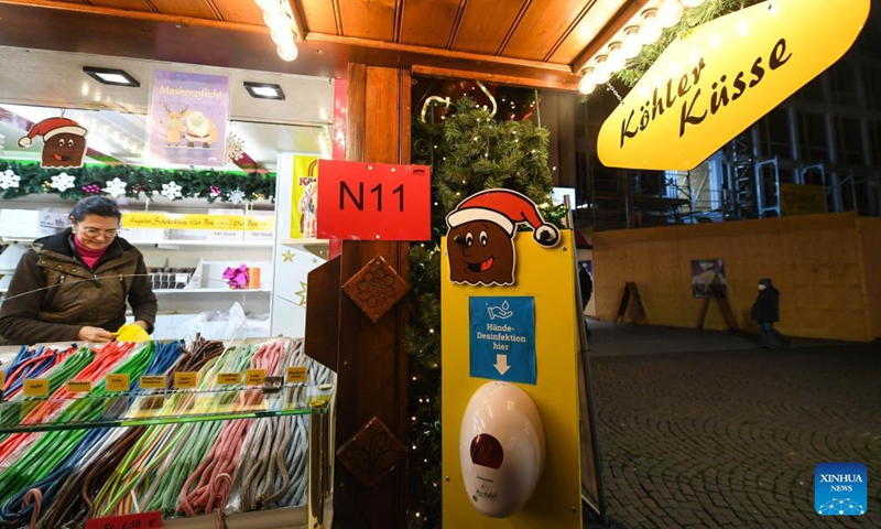 A hand sanitizer is seen next to a booth at the Frankfurt Christmas Market in Frankfurt, Germany, Nov. 22, 2021.Photo:Xinhua