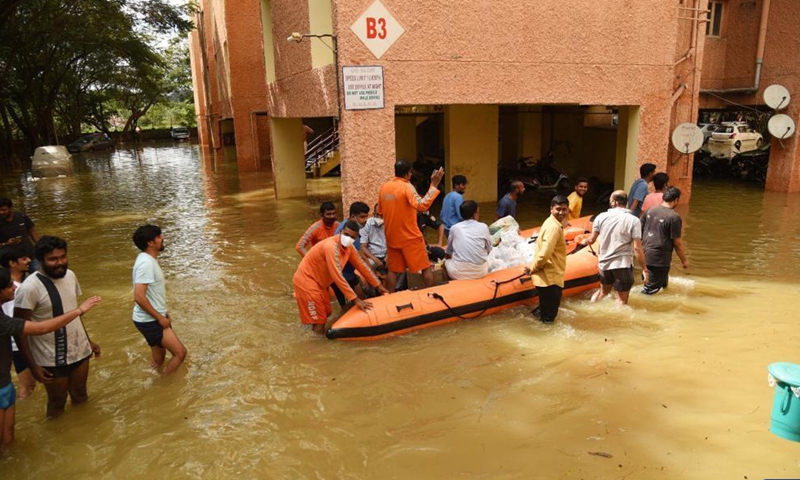 Rescuers evacuate residents from inundated areas after heavy rainfall in Bangalore, India, Nov. 22, 2021.Photo:Xinhua