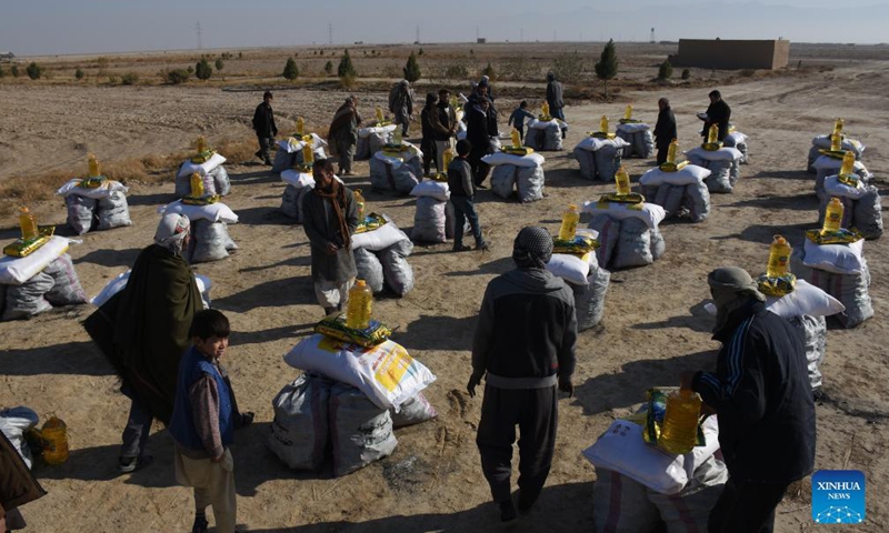 People receive relief assistance donated by a local philanthropist in Nahr Shahi district of Balkh province, Afghanistan, Nov. 21, 2021.Photo:Xinhua