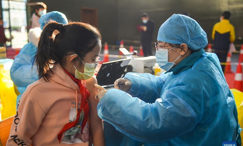 A kid receives a dose of COVID-19 vaccine at a school in Hohhot, north China's Inner Mongolia Autonomous Region, Nov. 23, 2021. Hohhot recently launched a COVID-19 vaccination campaign for children aged 3 to 11.Photo: Xinhua