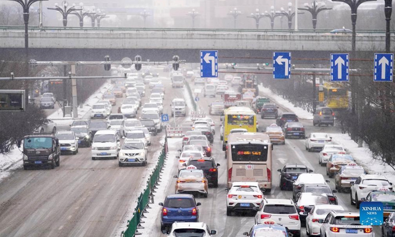 Vehicles move on an ice-cladded street in Harbin, northeast China's Heilongjiang Province, Nov. 22, 2021. Blizzards hit many parts of Heilongjiang on Monday.Photo:Xinhua