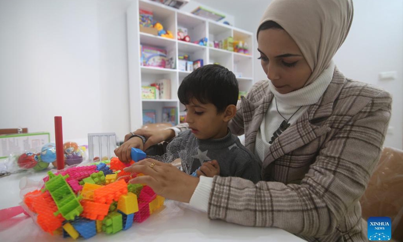 A Palestinian therapist interacts with a child at a local center for speech therapy and language rehabilitation in the southern Gaza Strip city of Rafah, Nov. 23, 2021.Photo:Xinhua
