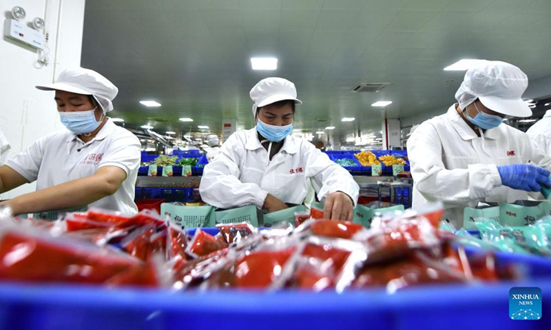 Workers pack Luosifen rice noodles at a food-processing company in Liuzhou, south China's Guangxi Zhuang Autonomous Region, Nov. 23, 2021.Photo:Xinhua