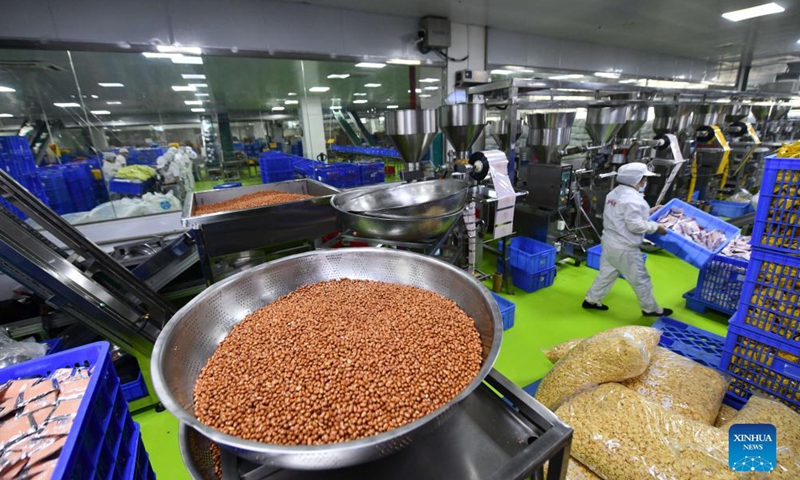 Workers work at a food-processing company in Liuzhou, south China's Guangxi Zhuang Autonomous Region, Nov. 23, 2021.Photo:Xinhua