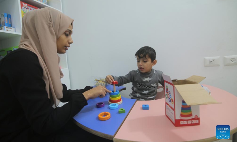 A Palestinian therapist interacts with a child at a local center for speech therapy and language rehabilitation in the southern Gaza Strip city of Rafah, Nov. 23, 2021.Photo:Xinhua