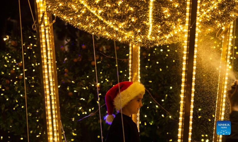 A child is seen with decorative lights in Syntagma Square in Athens, Greece, on Nov. 23, 2021.Photo:Xinhua
