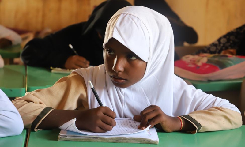 A student attends a class with a well-thumbed textbook at a primary school in Hajjah province, northern Yemen, Nov. 24, 2021.Photo:Xinhua