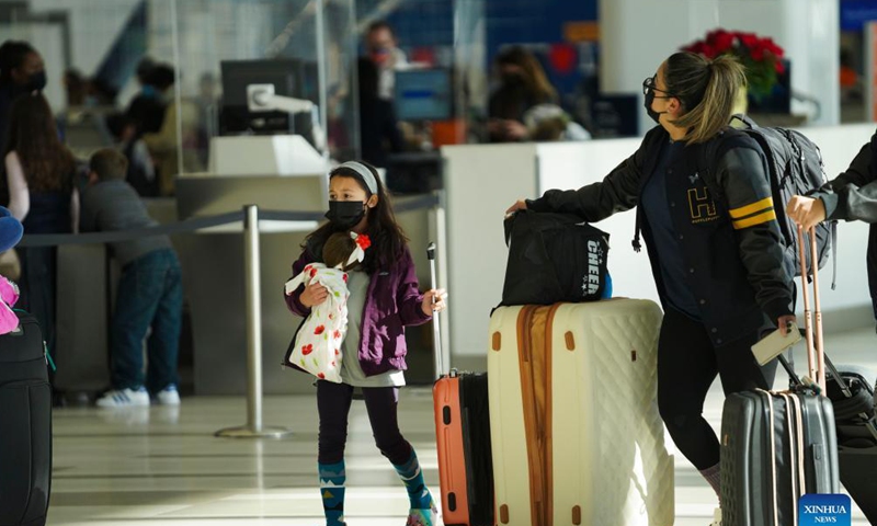 Travelers are seen at LaGuardia Airport in New York, the United States, Nov. 24, 2021. The U.S. Transportation Security Administration (TSA) expects airport security checkpoints nationwide will be busy during the upcoming Thanksgiving travel period, which runs from Nov. 19 to 28.Photo: Xinhua