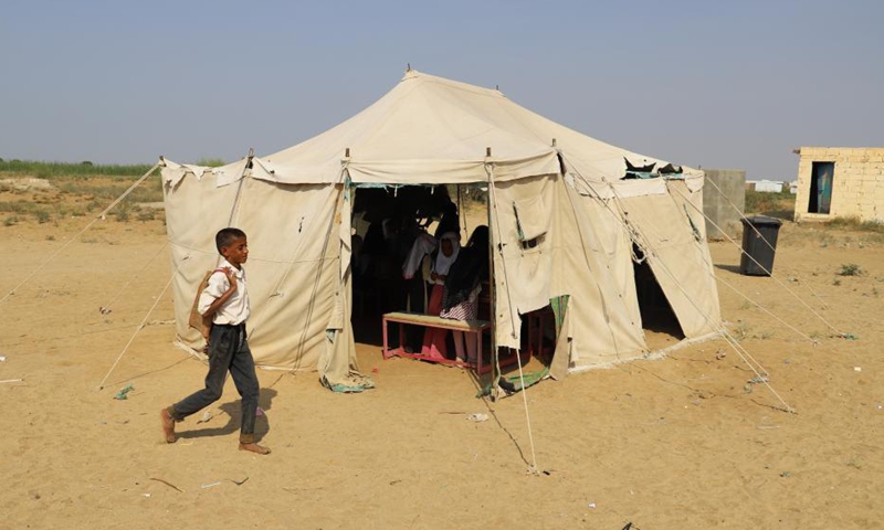 A student walks past a tent which serves as a classroom at a primary school in Hajjah province, northern Yemen, Nov. 24, 2021.Photo:Xinhua