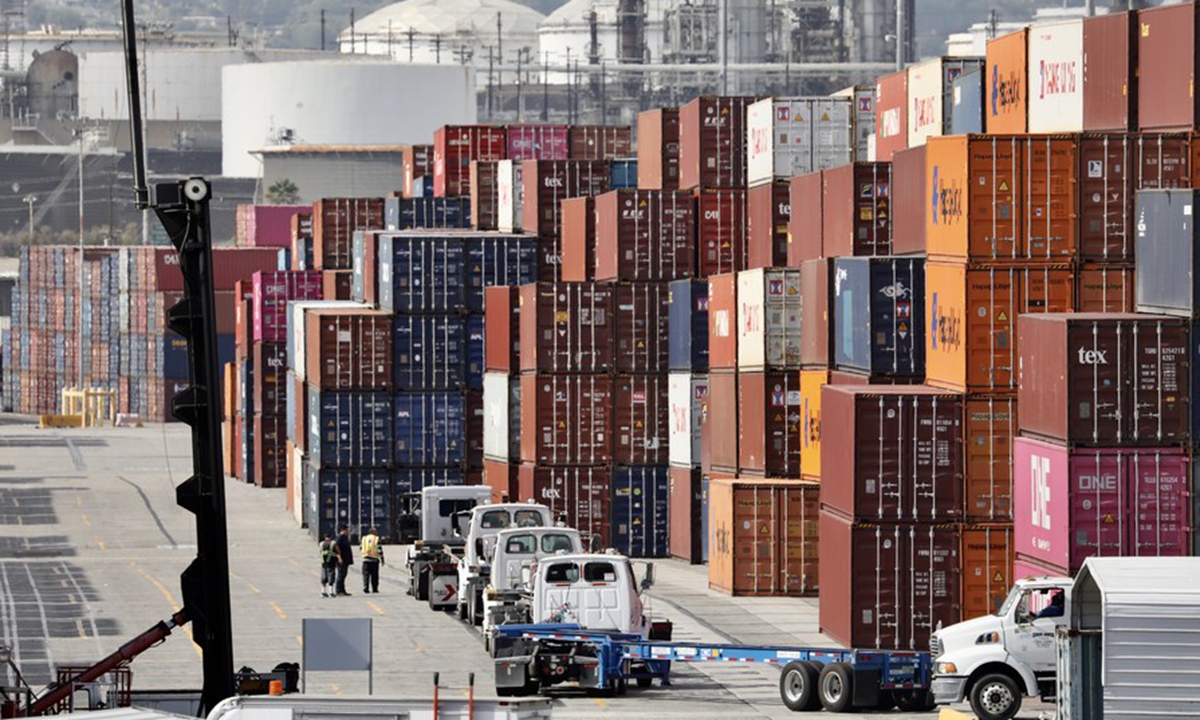 Trucks wait to load containers at the port of Los Angeles, California, the US, on Oct. 22, 2021. Photo: Xinhua