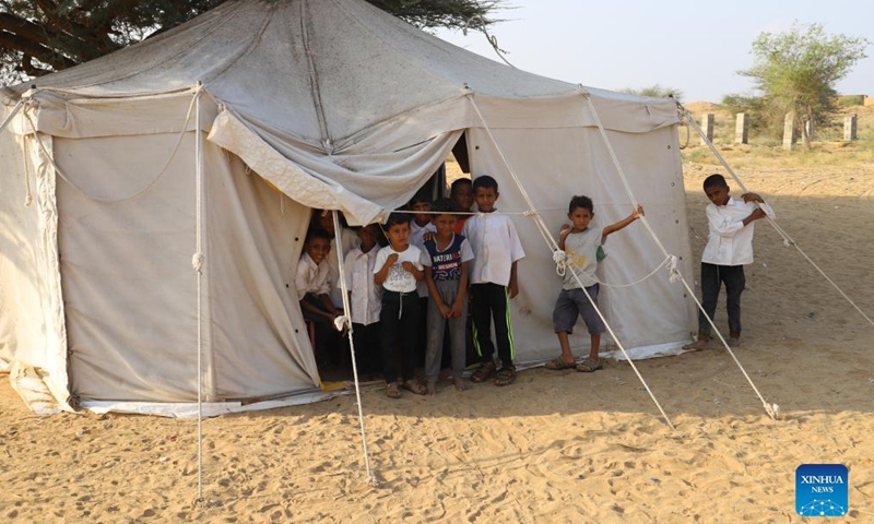 Students stand in front of a tent which serves as their classroom at a primary school in Hajjah province, northern Yemen, Nov. 24, 2021.Photo:Xinhua
