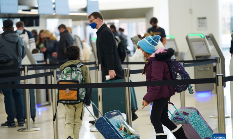 Travelers check in at LaGuardia Airport in New York, the United States, Nov. 24, 2021. The U.S. Transportation Security Administration (TSA) expects airport security checkpoints nationwide will be busy during the upcoming Thanksgiving travel period, which runs from Nov. 19 to 28.Photo: Xinhua