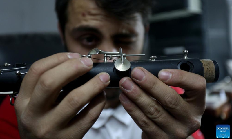 Palestinian Tariq Jabarin makes a wind musical instrument at his workshop in the West Bank city of Ramallah, Nov. 24, 2021. Photo: VCG