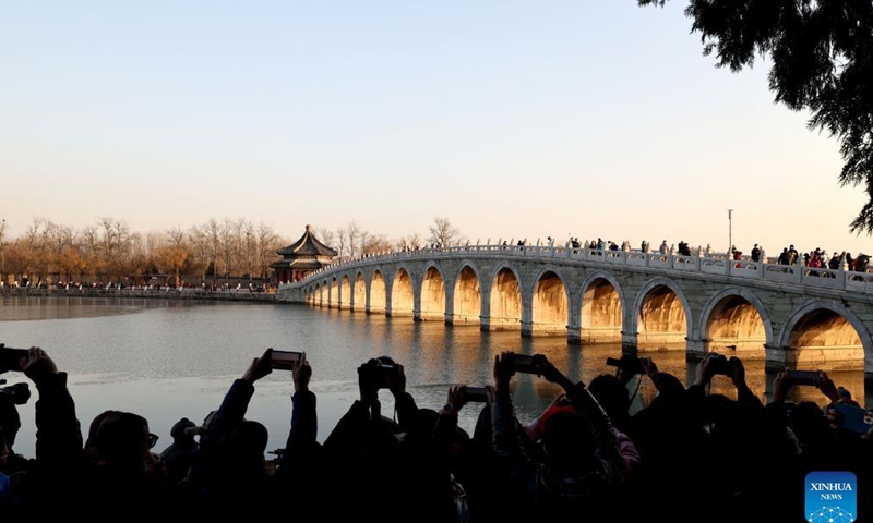 Photo taken on Nov. 25, 2021 shows the sunset illuminating the arches of the 17-Arch Bridge in the Summer Palace in Beijing, capital of China. Photo: Xinhua
