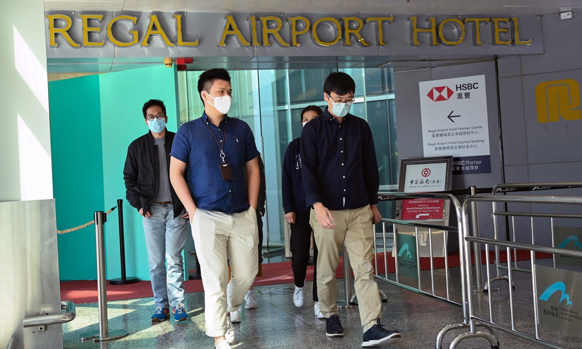 People leave the Regal Airport Hotel at Chek Lap Kok airport in Hong Kong on November 26, 2021, where a new Covid-19 variant deemed a 'major threat' was detected in a traveller from South Africa and who has since passed it on to a local man whilst in quarantine. Photo: AFP