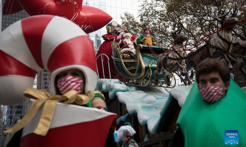 A performer dressed in Santa Claus costume rides on a float during the Macy's Thanksgiving Day Parade in New York, the United States, Nov 25, 2021.Photo:Xinhua