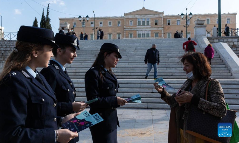 Policewomen give leaflets to passersby on the International Day for the Elimination of Violence against Women in Athens, Greece, Nov. 25, 2021.Photo:Xinhua