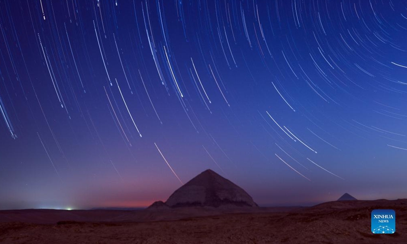Photomontage taken on Nov 26, 2021 shows star trails over the Bent Pyramid in Giza, Egypt. The Bent Pyramid with a history of more than four thousand years is located at Dahshur royal necropolis in Giza, south of Cairo. The pyramid belongs to Old Kingdom's Pharaoh Sneferu, and it was named as the Bent Pyramid or the Pyramid with Two Angles for having two different angles of inclination from base to top.Photo:Xinhua