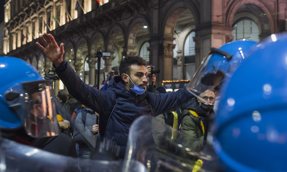 Hundreds of people gather in Milan, Italy on November 27, 2021 to demonstrate against a tightened green pass policy which will no longer allow access to 