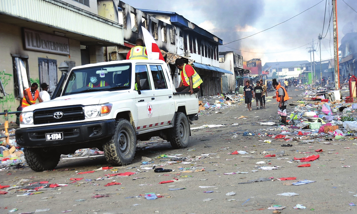 A Red Cross vehicle passes through the Chinatown district of Honiara, the Solomon Islands, on November 26, 2021.Photo: VCG