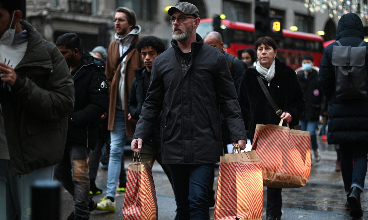 Shoppers make their way along Oxford Street on Black Friday, in central London on November 26, 2021. Photo: AFP